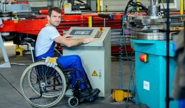 disabled man in wheelchair in manufacturing