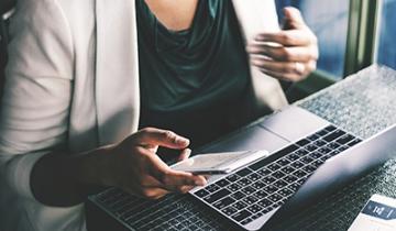 Woman on Laptop and Phone